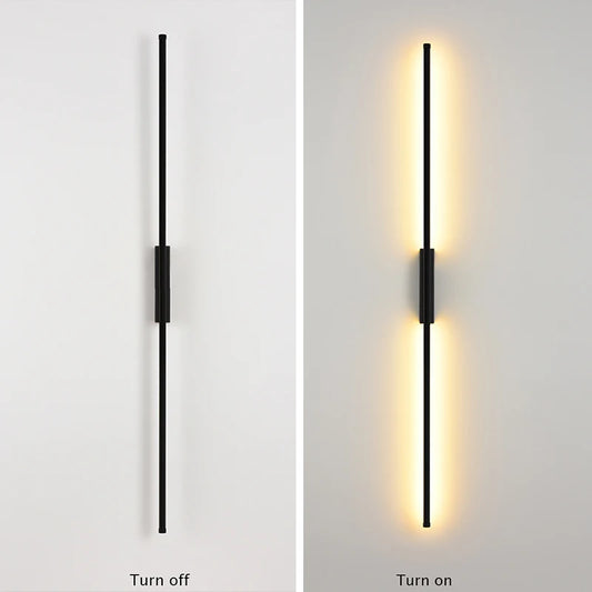 Black linear wall sconce in a turned-off state against a white wall.
