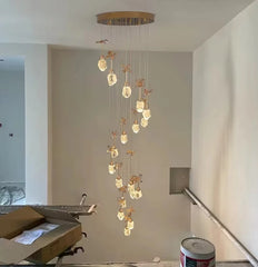 Modern chandelier hanging in a room with construction elements visible