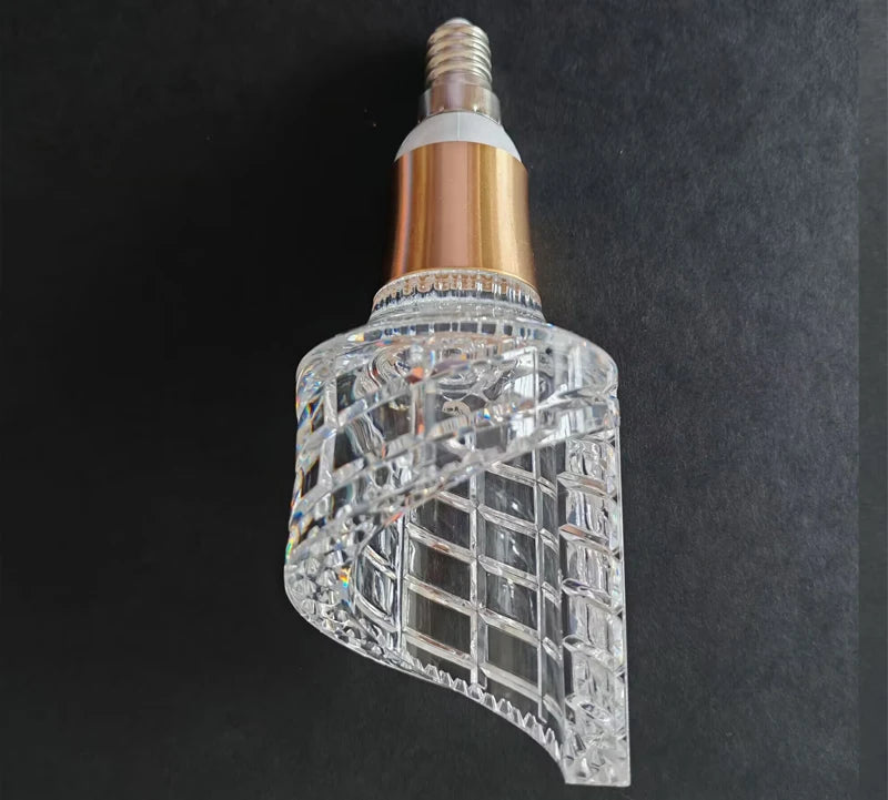 Decorative light bulb with crystal design on a dark background