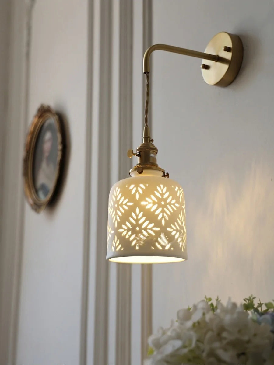 Wall-mounted lamp with decorative shade in a home setting