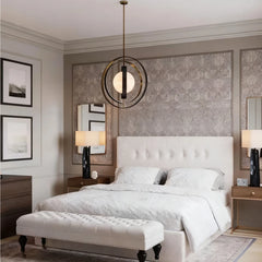 Modern bedroom with a bed, bench, and decorative wall art.