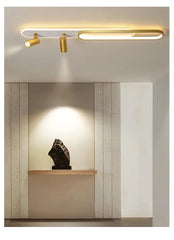 Modern ceiling light fixture in a room with a sculpture on a shelf.