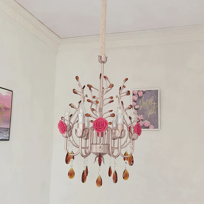 Side view of a pink and gold semi-flush mount chandelier adorned with ceramic roses and amber crystals, mounted on a textured ceiling.