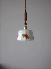 Pendant light with floral design on a plain background