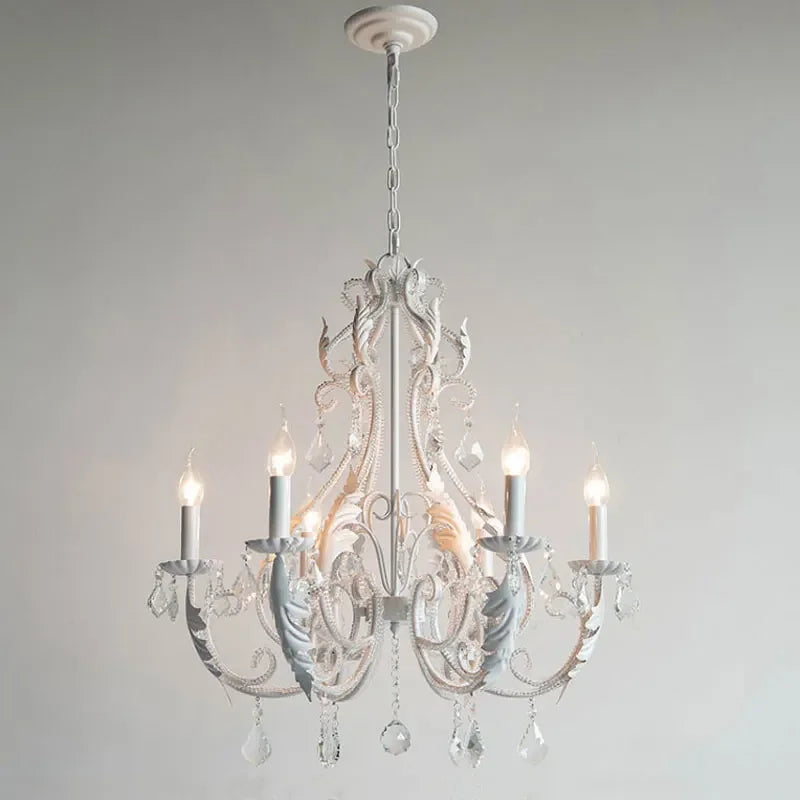 White chandelier with crystal accents on a plain background