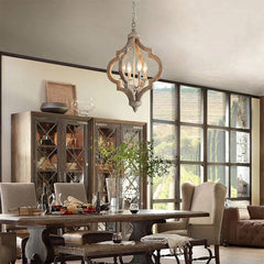 Dining room with wooden table, chairs, and a large window.