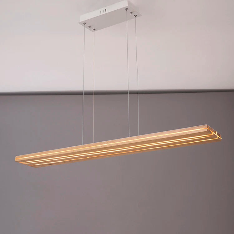 Modern pendant light fixture hanging against a gray wall
