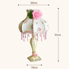 Decorative lamp with floral design and measurements on a white background