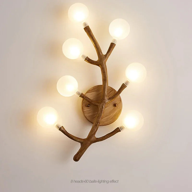 Wooden wall sconce with branch-like design on a light gray background
