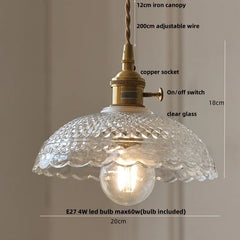 Pendant light with clear glass shade and brass fixture, featuring measurements and bulb information.