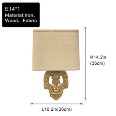 Wall-mounted lamp with beige shade and decorative base, showing dimensions and material details.