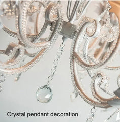 Close-up of a crystal pendant decoration on a light gray background