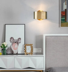 Modern interior with a white cabinet, gold wall lamp, and framed picture of a koala.