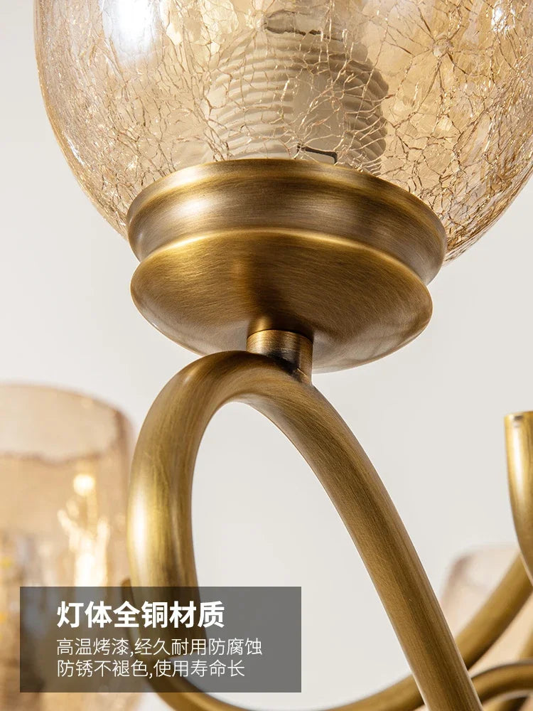Detailed view of the brass material and construction of a gold chandelier arm and socket.