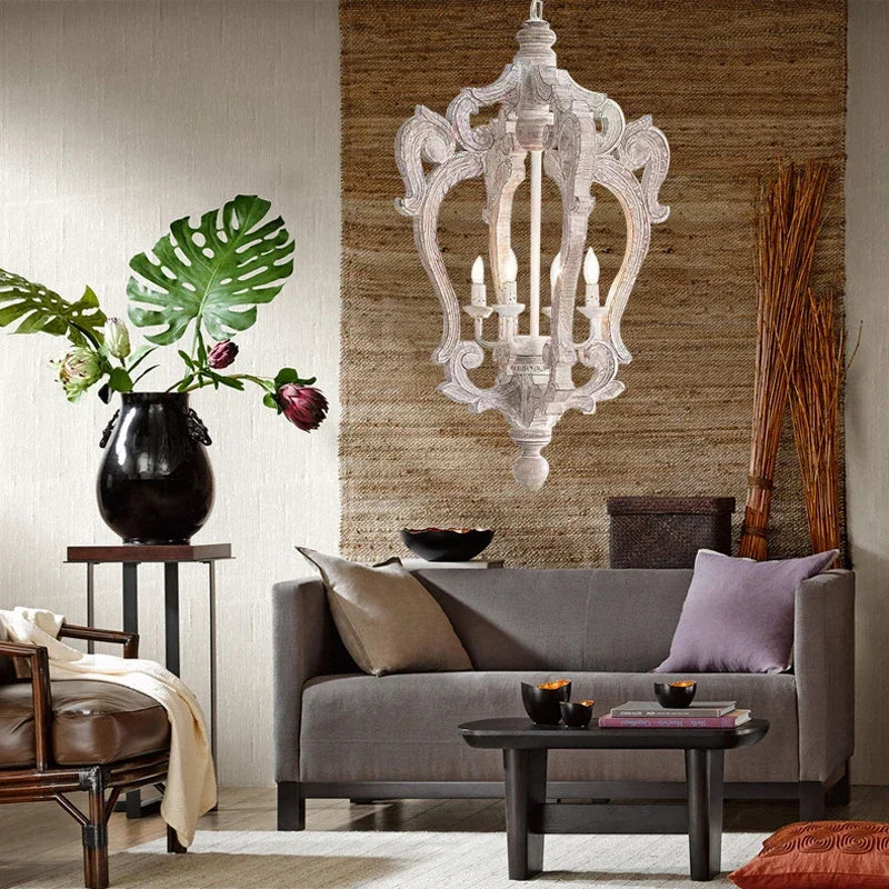 Living room with gray sofa, decorative pillows, and a large white chandelier.