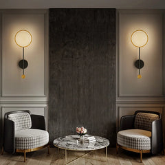 Modern interior with two armchairs and a coffee table under wall lights.