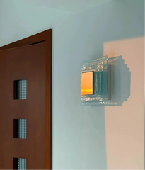Modern wall-mounted light fixture on a light blue wall