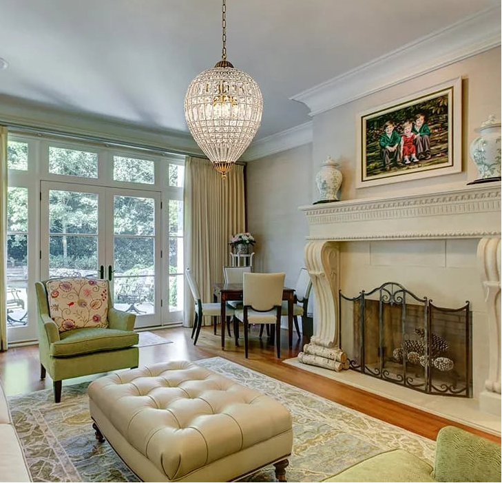 Living room with a chandelier, fireplace, and family photo on the wall.