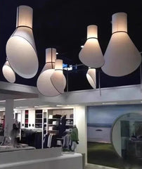 Large light bulb-shaped lamps hanging in a store setting