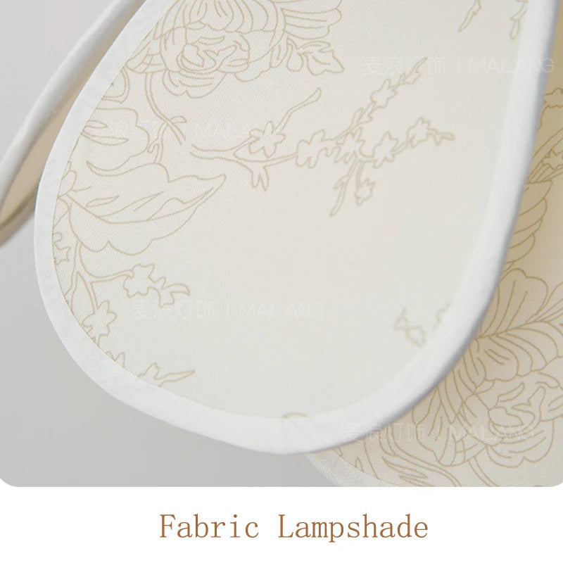 Fabric lampshade with floral pattern on a matching fabric surface