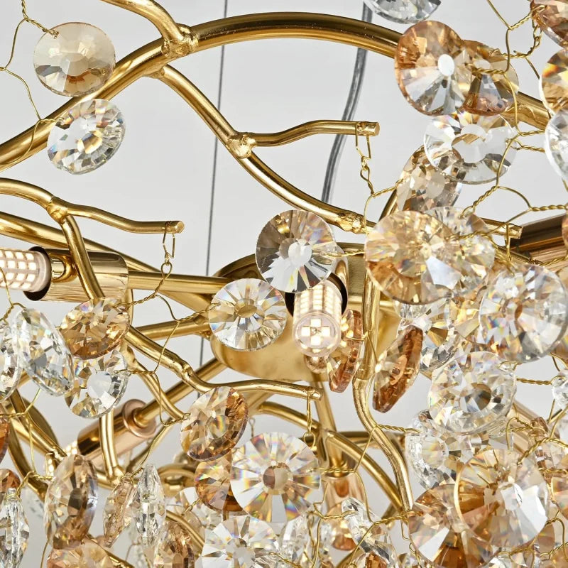 Close-up of a gold chandelier with crystal-like beads on a neutral background
