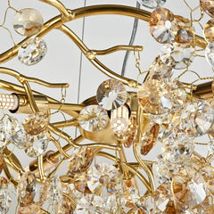Close-up of a gold chandelier with crystal-like beads on a neutral background