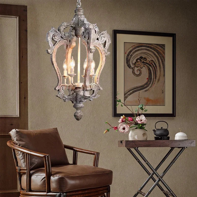 Decorative chandelier hanging above a brown armchair with a small table and floral arrangement in the foreground.