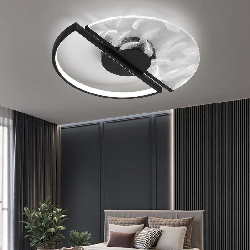 Black and white circular ceiling light with feather pattern glass shade and black frame, in a bedroom setting.