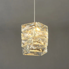 Clear glass pendant light on a dark gray background
