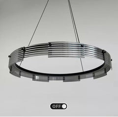 Modern pendant light fixture with a metallic design on a gray background