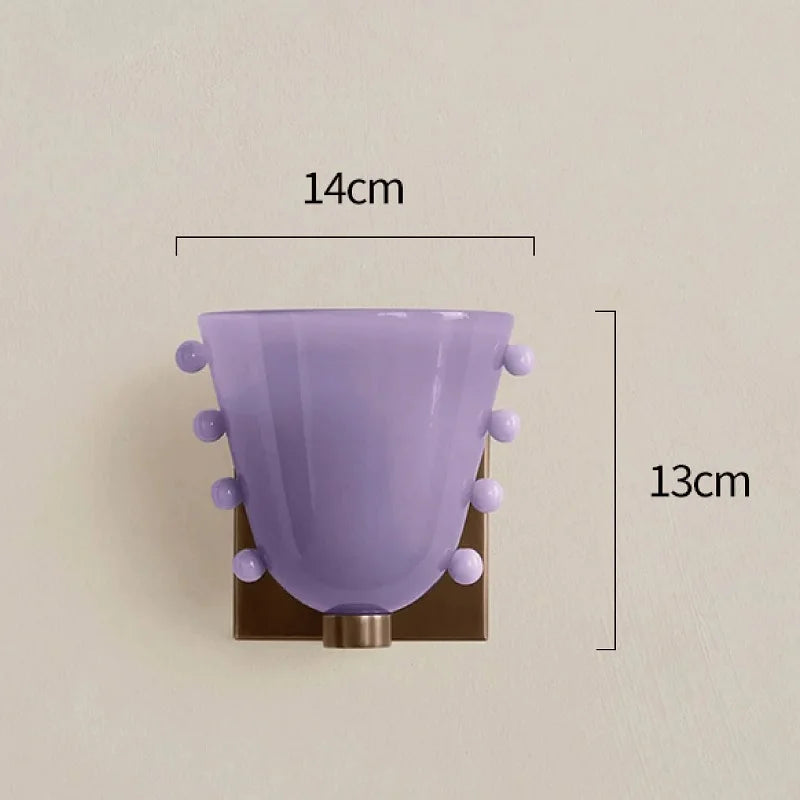 Purple wall sconce with measurements on a beige background