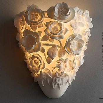 Decorative wall light with floral design on a dark background