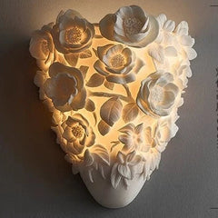 Decorative wall light with floral design on a dark background