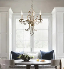 Dining room with a chandelier, table, and chairs.