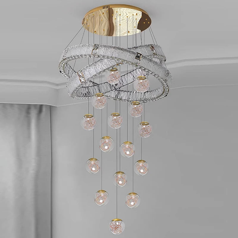 Chandelier with crystal balls and gold accents on a gray background