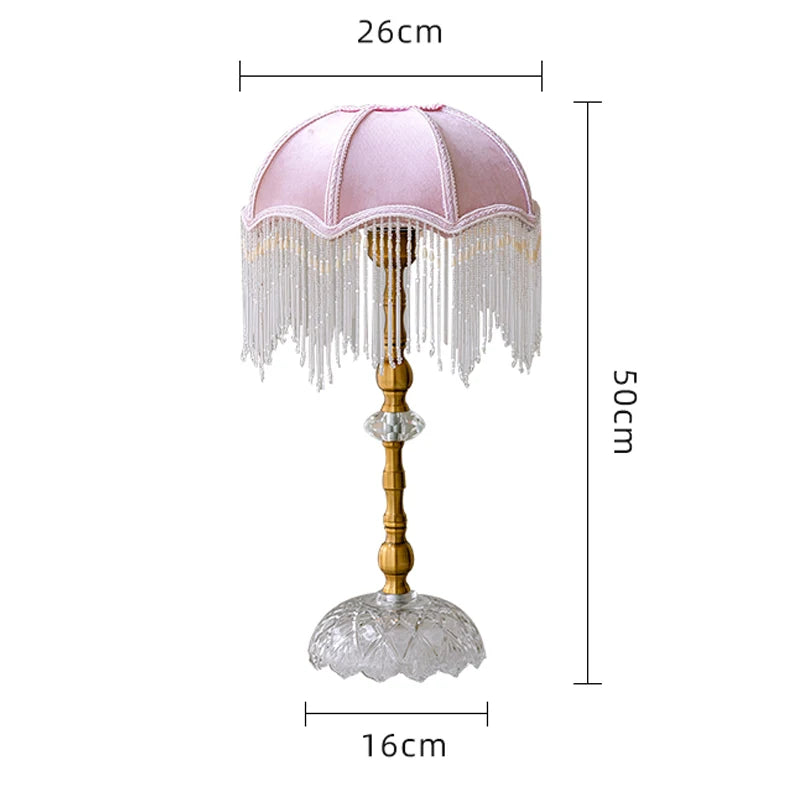 Decorative lamp with pink shade and tassels, dimensions indicated.