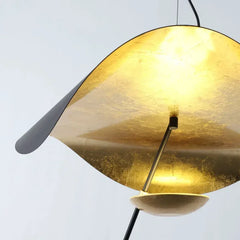 Gold pendant lamp with a gray shade on a light gray background
