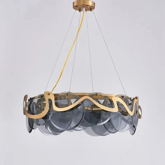 Close-up of a gold wavy glass pendant light fixture