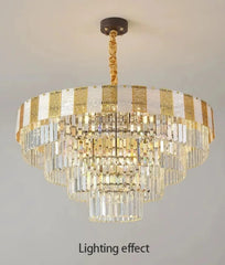 Tiered faceted crystal chandelier with polished chrome accents and a central light source, suspended from a ceiling.