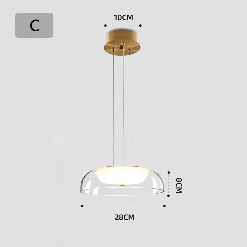 Gold pendant light with clear glass shade and dimensions on a white background