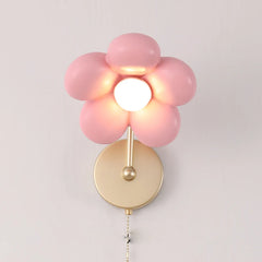 Pink flower-shaped wall light fixture on a plain background