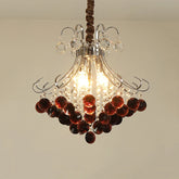 Close-up view of a crystal chandelier with wine red accents, showcasing its polished finish and intricate design.