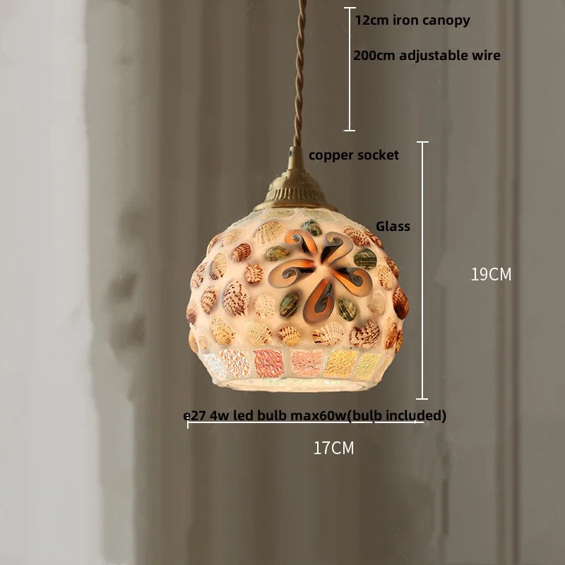 Decorative pendant light with measurements on a plain background