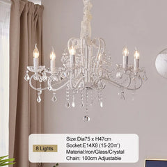 Crystal chandelier hanging in a room with a neutral color scheme
