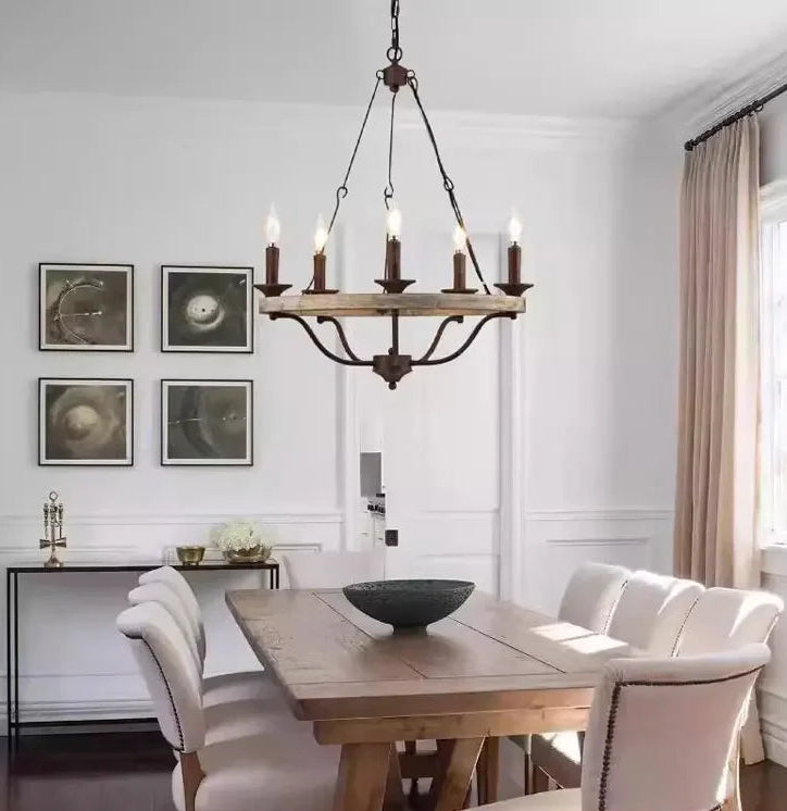 Dining room with wooden table, chairs, and a chandelier.