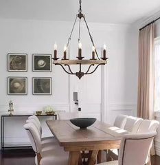 Dining room with wooden table, chairs, and a chandelier.