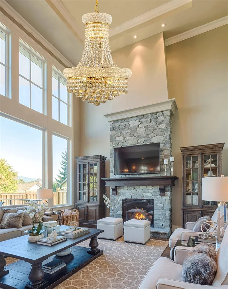 Luxurious living room with a chandelier, fireplace, and large windows.