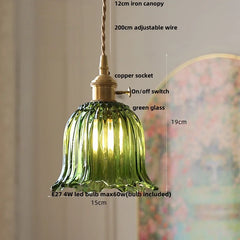 Green glass pendant light with measurements and features on a neutral background