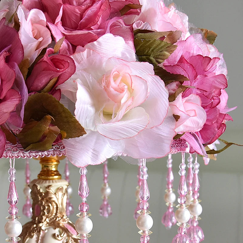 Floral chandelier with pink and white flowers and decorative beads.