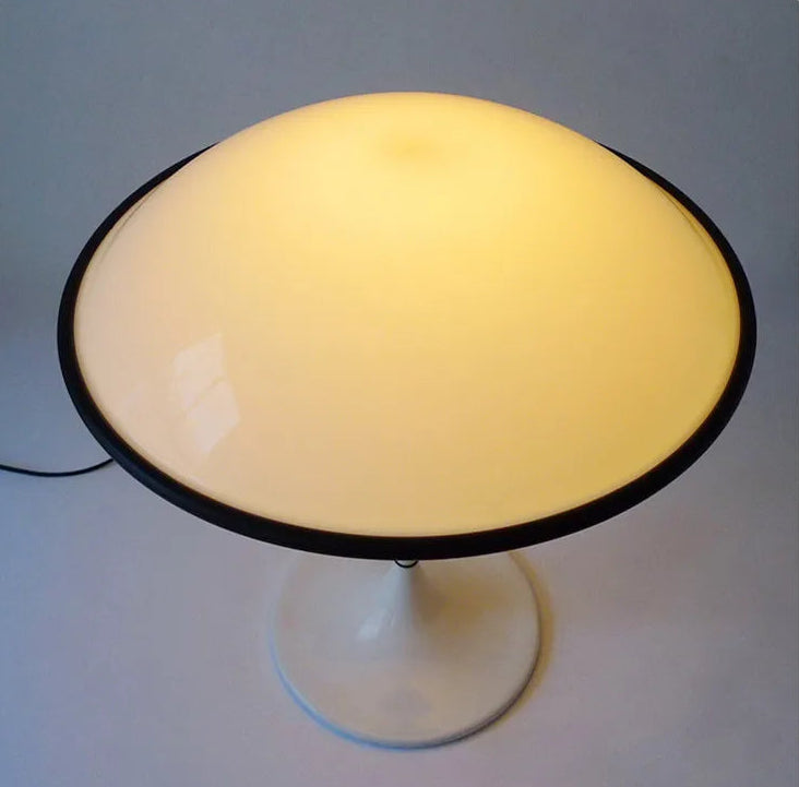 Table lamp with a yellow shade on a gray background